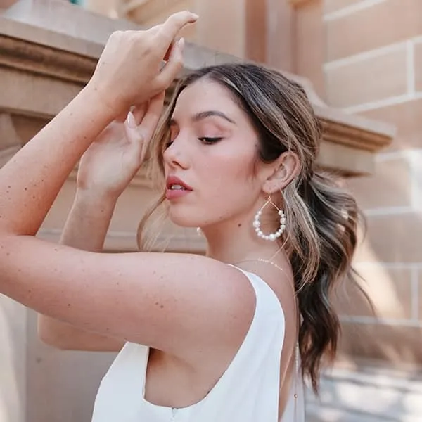 Model wearing fine pearl and gold jewellery